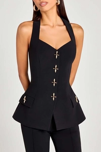 Detail of black halter vest with gold cross buckles and tailored flap pockets