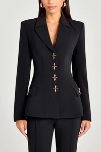 Detailed view of the structured hourglass waist and golden star-shaped buttons on a black blazer