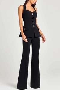 Detail of black tailored vest with gold cross buttons and matching high waist wide leg pants
