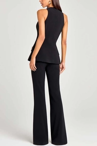 Detail of black waist-fitting vest with gold buttons and matching flared trousers set
