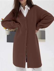 Detail of coffee brown long knit cardigan featuring drop shoulders and button closure