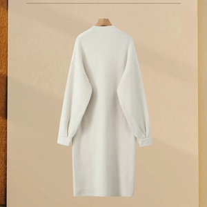 Detail of soft cream knit cardigan showing loose fit cut and textured ribbed cuffs