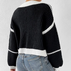 Back view of a chunky knit cardigan with black and white color blocking and loose fit