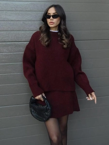 Detail view of burgundy knit set featuring a soft crewneck sweater and matching skirt
