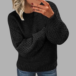 Detailed view of women's black round neck sweater featuring textured honeycomb knit patterns