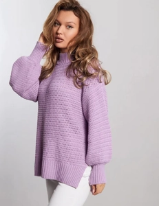 Detailed side view of purple knit sweater with high neck and stylish side slit hemline