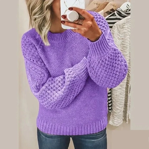 Detail of purple chunky knit sweater featuring retro lantern sleeves and ribbed cuffs