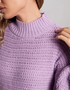 Detailed macro view of the lavender knit sweater with hollow-out pattern and ribbed stand collar