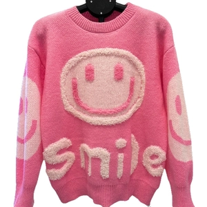 Pink oversized knit sweater featuring a 3D smile design and dropped shoulders