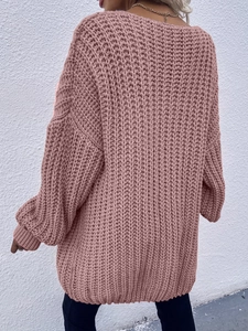 Detailed back view of dusty pink cable knit cardigan showing chunky texture and loose fit