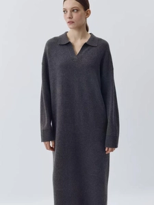 Detailed texture of charcoal grey knit polo dress with deep V-neck and soft wool blend fabric