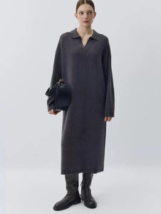 Detail of loose dark grey wool blend knitted dress with elegant polo neck and long sleeves