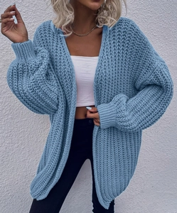 Detailed close-up showing the thick knit texture and soft blue wool on this cozy cardigan