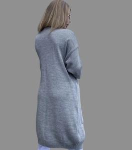 Rear view of a long grey knitted cardigan sweater for women in a loose fit design