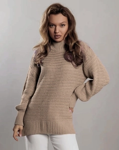 Detail view of khaki chunky knit sweater with ribbed cuffs and textured stitch pattern