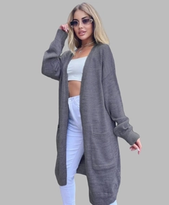 Detail of dark grey oversized knit cardigan showing long cut and large square patch pockets