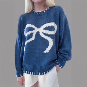 Navy blue oversized knit sweater with white bow jacquard and whipstitch details