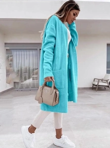 Detail view of teal oversized knit cardigan featuring ribbed cuffs and large side pockets