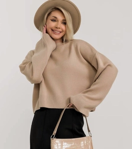 Dettaglio del maglione oversize in maglia color avena con polsini a costine e texture