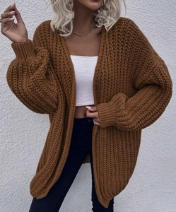 Detailed view of brown chunky knit cardigan with oversized lantern sleeves and thick texture