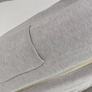 Detail view of the ribbed knit pocket and soft gray fabric on the women's cardigan