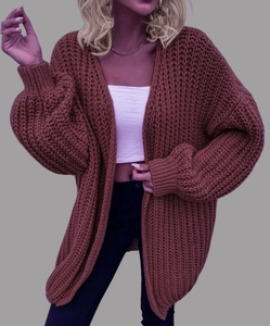 Close-up of loose-knit oversized red-brown cardigan with lantern sleeves and drop shoulders