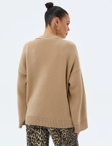 Détail du cardigan en maille kaki avec épaules tombantes et finitions côtelées sur modèle