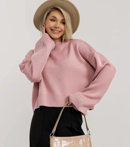 Dettaglio del maglione in maglia rosa oversize con polsini a coste e trama spessa