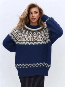 Detail of Fair Isle jacquard pattern on soft navy blue Christmas knitted sweater
