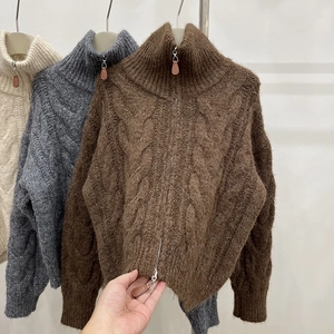 Detail of cable knit wool sweaters with silver zippers and leather pullers in three colors