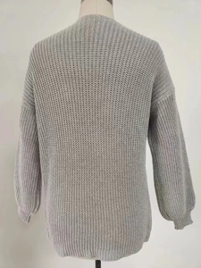 Detail view showing back texture of gray knit cardigan with dropped shoulder seams