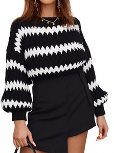 Detail of knitted sweater with contrast zigzag pattern and ribbed lantern sleeves
