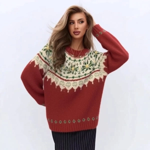 Detailed view of Fair Isle snowflake knit pattern on a red vintage Christmas sweater