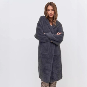 Detail of soft dark grey plush long cardigan with hood and front pockets for winter