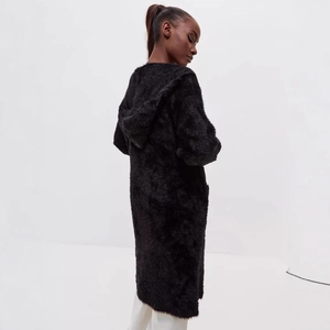 Back view of a long black faux fur hooded cardigan with soft plush texture for winter