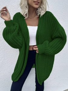 Deep green oversized knit cardigan with chunky cable knit texture and drop shoulder design