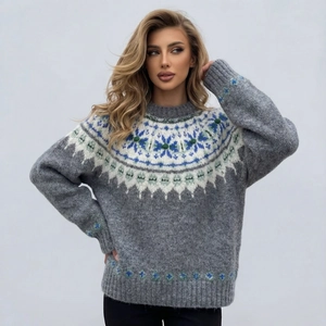 Close-up of Fair Isle knit sweater featuring blue and white snowflake jacquard patterns