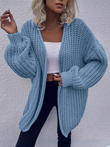Women's oversized blue chunky knit cardigan sweater with ribbed cuffs in a loose casual style