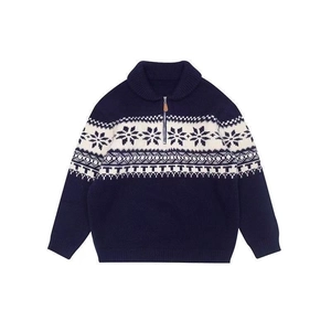 Close-up of navy blue knit sweater featuring classic white snowflake jacquard pattern