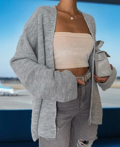 Detail of grey chunky knit cardigan showing thick texture and drop shoulder design