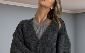 Detail of dark grey oversized knit cardigan with soft texture and lantern sleeves
