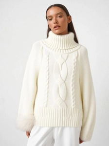 White high-neck cable-knit sweater poncho with luxury fox fur cuffs for a winter style
