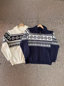 Women's Nordic snowflake jacquard polo knit sweaters in cream and navy blue flat lay