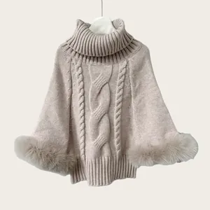 Macro view of oatmeal cable knit texture and premium faux fur hem on turtleneck cape