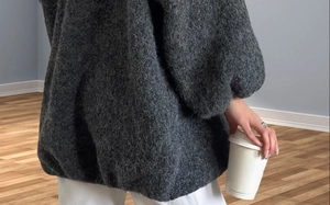 Close-up of soft grey mohair knit cardigan with fuzzy texture and lantern sleeves