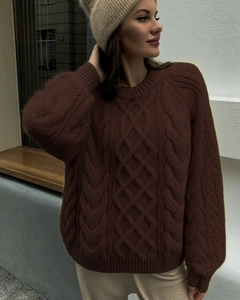 Detailed cable knit pattern on a loose oversized dark brown crewneck sweater