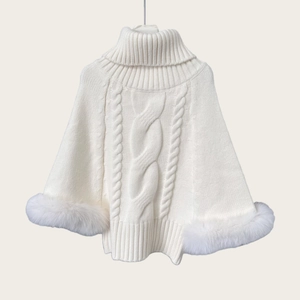 Close-up of white cable knit poncho sweater with luxurious fox fur trim on cuffs