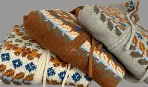 Close-up of Fair Isle knit fabric textures with vintage floral patterns and woven drawstrings