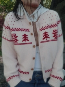 Women's vintage Christmas knit cardigan with red festive patterns on cream base fabric