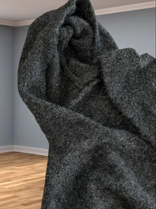 Detailed texture of thick dark grey wool knit hooded cardigan for winter warmth